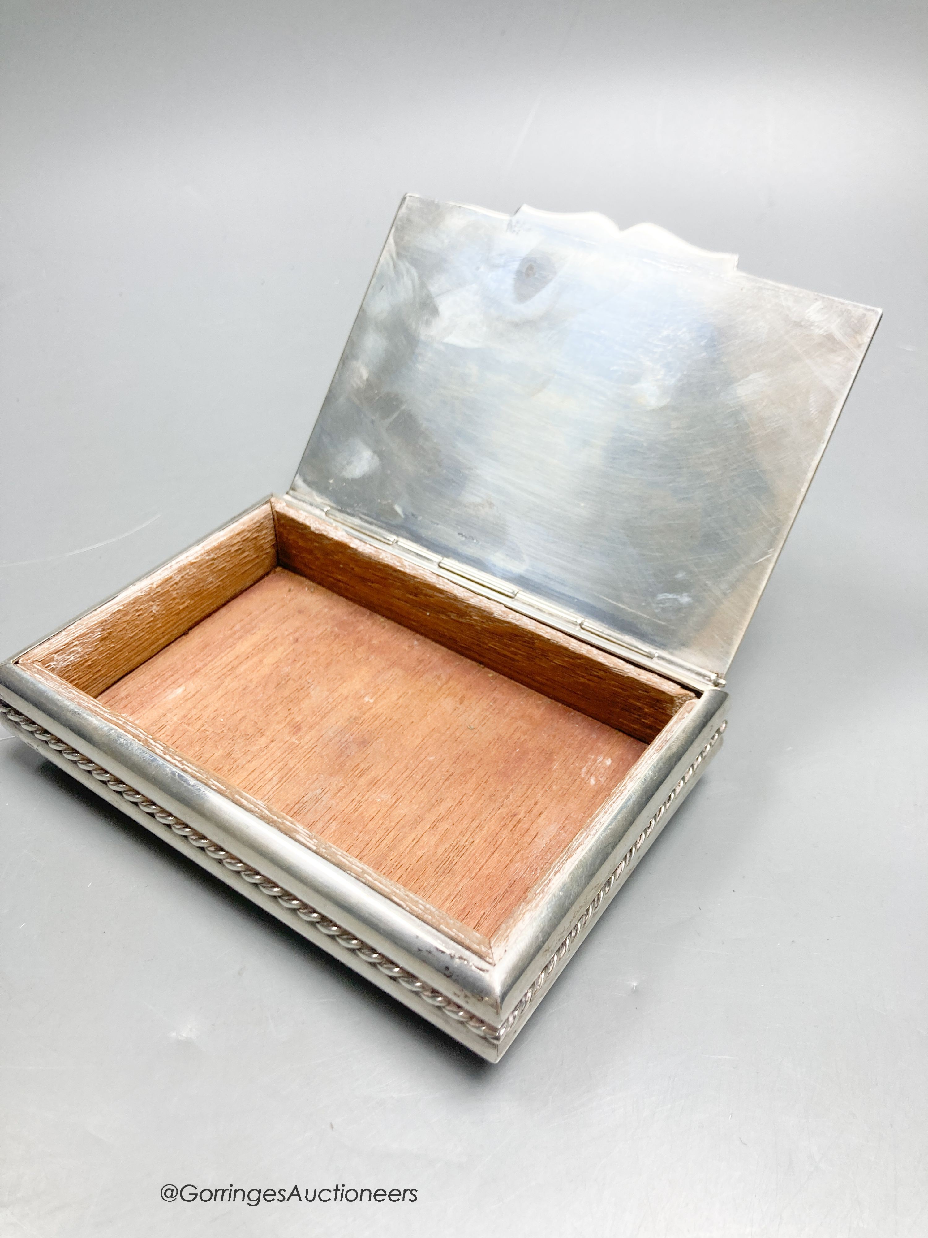 A 20th century Cartier sterling mounted rectangular cigarette box, on bun feet